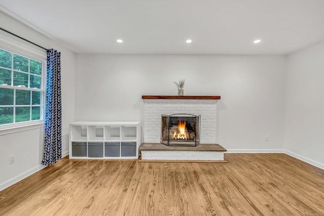 6 Buckboard Ln, Fairfield, CT 06824 - unfurnished living room with wood finished floors, a brick fireplace, and recessed lighting