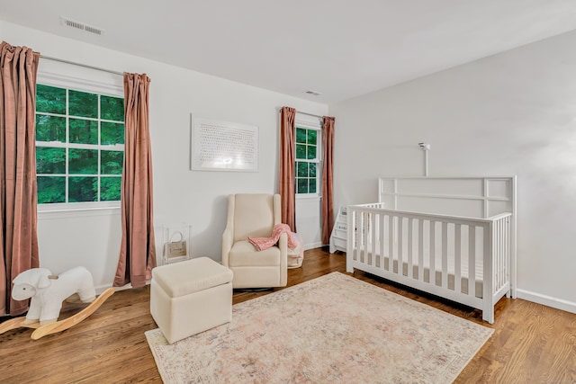 6 Buckboard Ln, Fairfield, CT 06824 - bedroom with wood finished floors and a nursery area