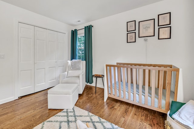 6 Buckboard Ln, Fairfield, CT 06824 - bedroom with wood finished floors, a closet, and a nursery area