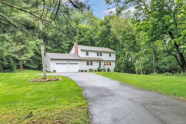 6 Buckboard Ln, Fairfield, CT 06824 - colonial-style house featuring a garage, a chimney, asphalt driveway, a front yard, and a view of trees
