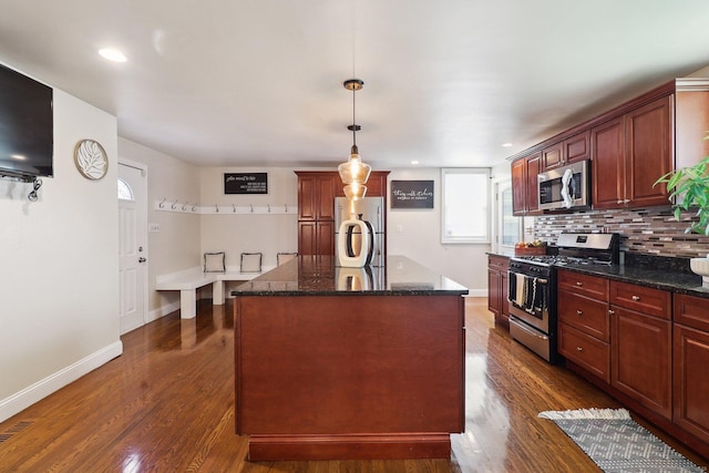 98 Herald Ave, Bridgeport, CT 06606 - kitchen with appliances with stainless steel finishes, baseboards, dark wood-style flooring, backsplash, and dark stone counters