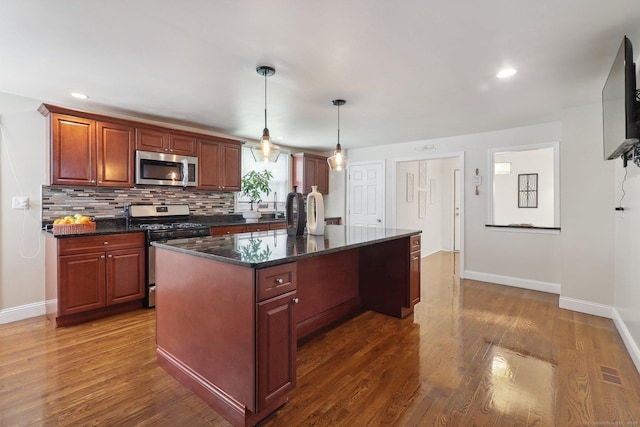 98 Herald Ave, Bridgeport, CT 06606 - kitchen with stainless steel appliances, baseboards, dark wood-style floors, a kitchen island, and recessed lighting