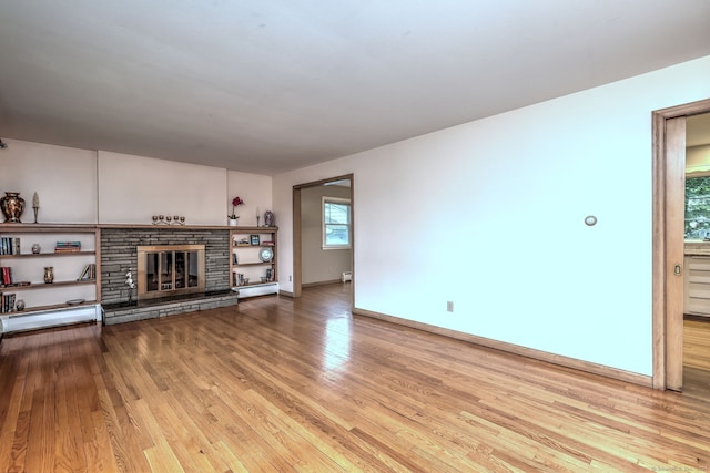 15 Edgemere Rd, Hamden, CT 06517 - unfurnished living room with wood finished floors, healthy amount of natural light, and a fireplace