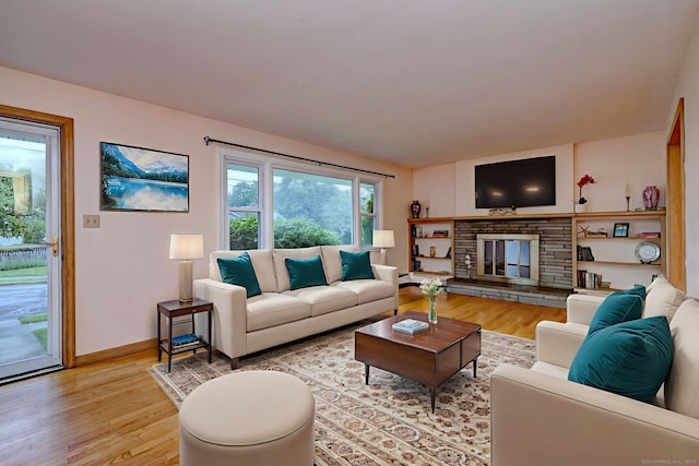15 Edgemere Rd, Hamden, CT 06517 - living room with light wood-style flooring and a stone fireplace