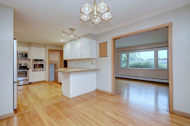 15 Edgemere Rd, Hamden, CT 06517 - kitchen featuring appliances with stainless steel finishes, baseboard heating, a peninsula, a chandelier, and backsplash