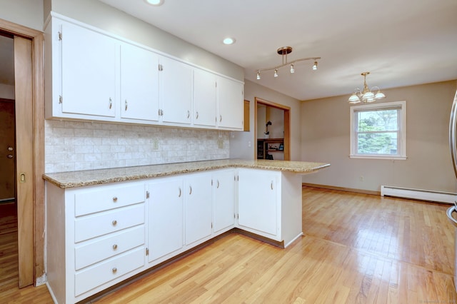 15 Edgemere Rd, Hamden, CT 06517 - kitchen featuring a baseboard heating unit, decorative backsplash, light wood-style flooring, white cabinets, and recessed lighting