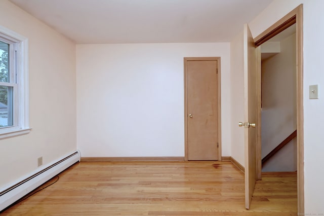 15 Edgemere Rd, Hamden, CT 06517 - empty room with baseboard heating and light wood-style floors