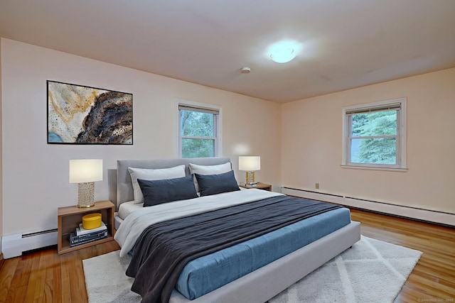 15 Edgemere Rd, Hamden, CT 06517 - bedroom featuring a baseboard heating unit, multiple windows, and light wood finished floors