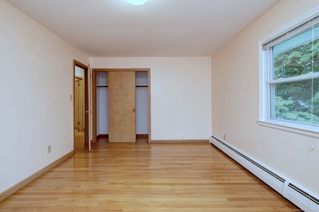 15 Edgemere Rd, Hamden, CT 06517 - unfurnished bedroom with baseboard heating, light wood-style floors, and a closet