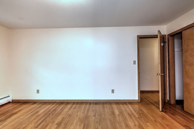 15 Edgemere Rd, Hamden, CT 06517 - unfurnished bedroom featuring light wood-style floors, a baseboard radiator, and a closet
