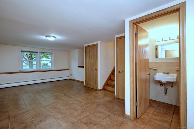 15 Edgemere Rd, Hamden, CT 06517 - empty room with baseboard heating, stairs, and light tile patterned flooring