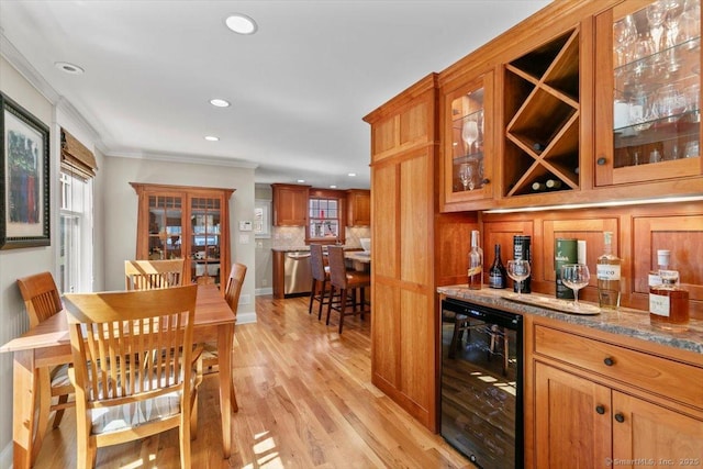 10 Point Beach Dr, Milford, CT 06460 - indoor dry bar featuring wine cooler, crown molding, light wood-style floors, recessed lighting, and stainless steel dishwasher