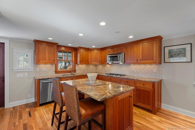 10 Point Beach Dr, Milford, CT 06460 - kitchen with stainless steel appliances, brown cabinetry, light wood-type flooring, tasteful backsplash, and ornamental molding