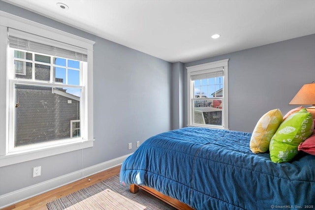 10 Point Beach Dr, Milford, CT 06460 - bedroom featuring multiple windows, wood finished floors, and recessed lighting