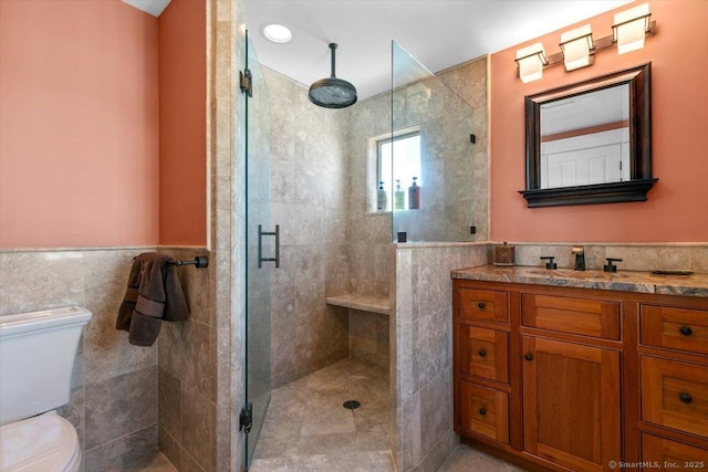 10 Point Beach Dr, Milford, CT 06460 - full bath featuring tile walls, a shower stall, vanity, and a wainscoted wall