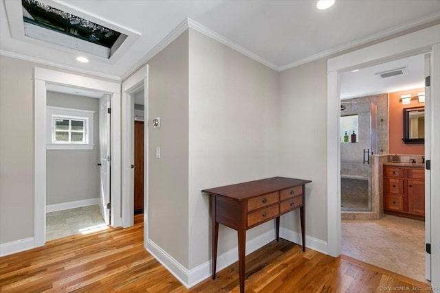 10 Point Beach Dr, Milford, CT 06460 - hallway featuring light wood-style floors, ornamental molding, and recessed lighting