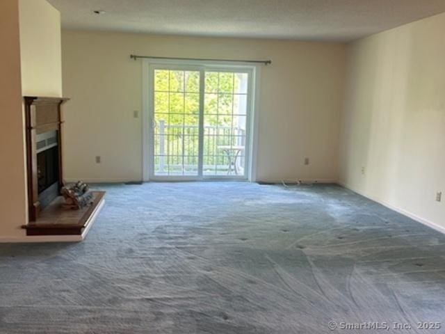 749 Long Hill Rd Unit A, Middletown, CT 06457 - unfurnished living room with carpet floors and a fireplace with raised hearth