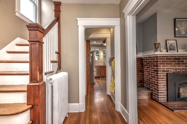 17 Norris St, Hamden, CT 06517 - hall featuring radiator heating unit, stairs, and wood-type flooring