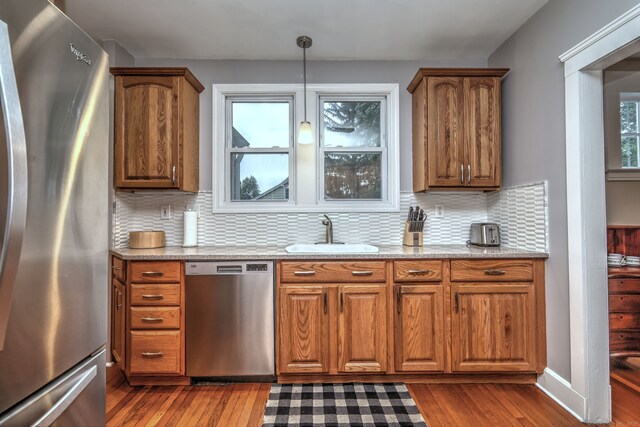 17 Norris St, Hamden, CT 06517 - kitchen featuring stainless steel appliances, dark wood-type flooring, brown cabinetry, and backsplash