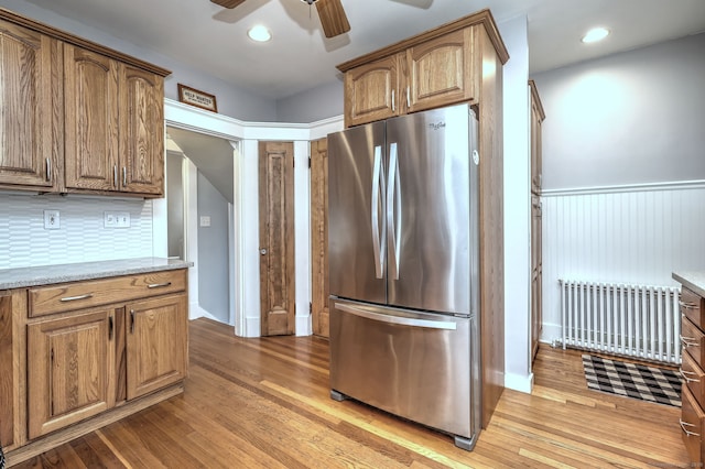 17 Norris St, Hamden, CT 06517 - kitchen featuring freestanding refrigerator, radiator heating unit, light wood-style floors, ceiling fan, and a wainscoted wall