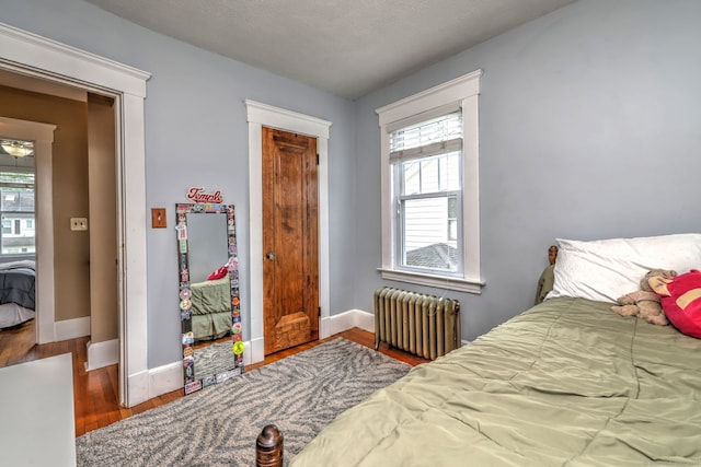 17 Norris St, Hamden, CT 06517 - bedroom with radiator heating unit and wood finished floors