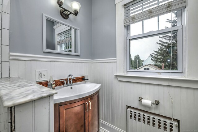 17 Norris St, Hamden, CT 06517 - bathroom with radiator, vanity, and wainscoting