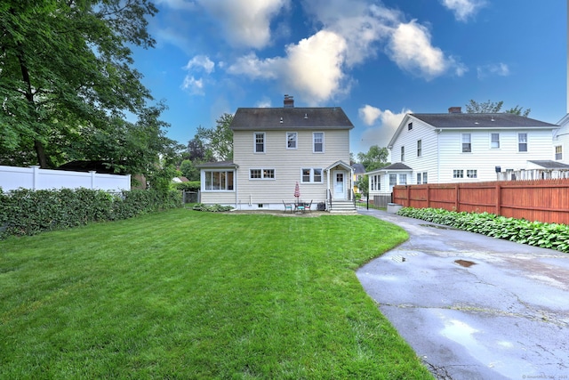 17 Norris St, Hamden, CT 06517 - rear view of house with entry steps, a fenced backyard, a patio area, and a chimney
