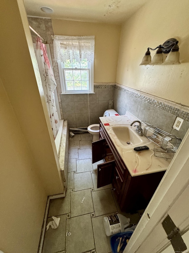 38 Makara St, Plymouth, CT 06786 - bathroom with tile walls, vanity, toilet, wainscoting, and tiled shower / bath
