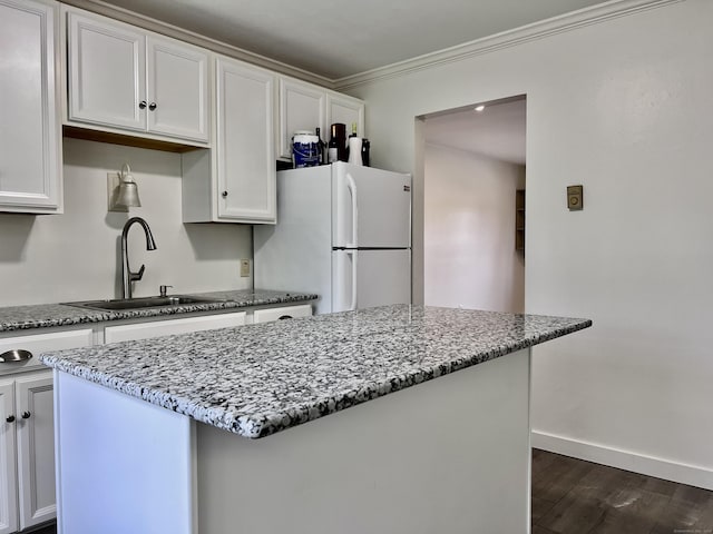 4 Belair Dr Unit 4, New Milford, CT 06776 - kitchen with freestanding refrigerator, a sink, stone counters, dark wood-style flooring, and a center island