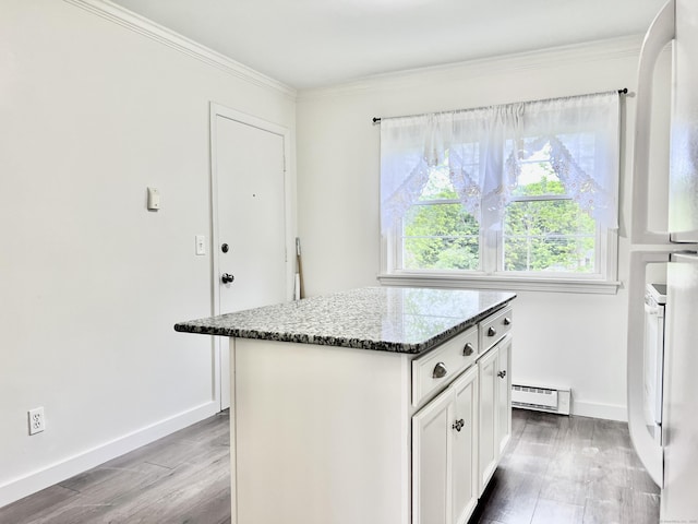4 Belair Dr Unit 4, New Milford, CT 06776 - kitchen with baseboard heating, ornamental molding, a kitchen island, dark stone countertops, and wood finished floors