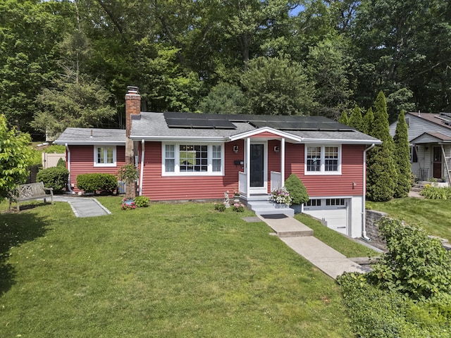 96 Long Hill Ter, New Haven, CT 06515 - view of front facade featuring roof mounted solar panels, a chimney, a front yard, an attached garage, and driveway