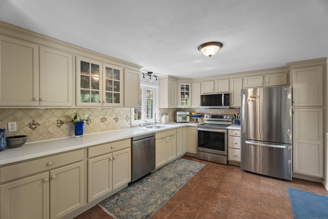 96 Long Hill Ter, New Haven, CT 06515 - kitchen with stainless steel appliances, cream cabinets, tasteful backsplash, a sink, and light countertops