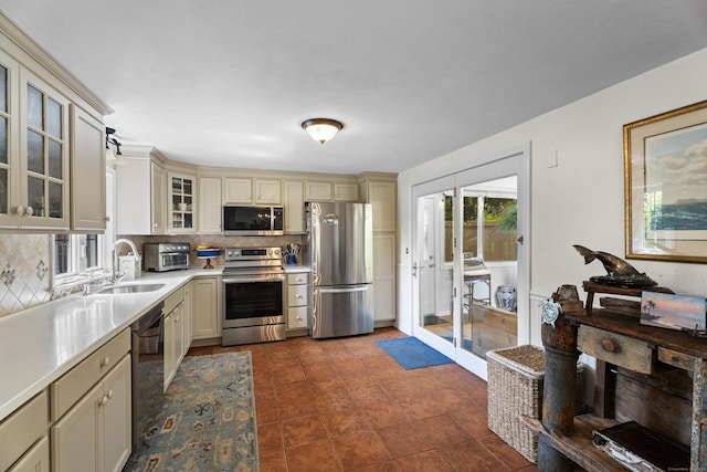 96 Long Hill Ter, New Haven, CT 06515 - kitchen with stainless steel appliances, a sink, cream cabinetry, and decorative backsplash