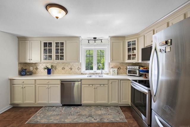 96 Long Hill Ter, New Haven, CT 06515 - kitchen featuring appliances with stainless steel finishes, cream cabinets, a sink, and decorative backsplash