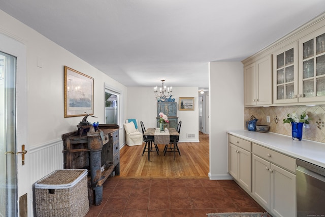 96 Long Hill Ter, New Haven, CT 06515 - kitchen featuring dishwasher, a chandelier, glass insert cabinets, decorative backsplash, and light countertops