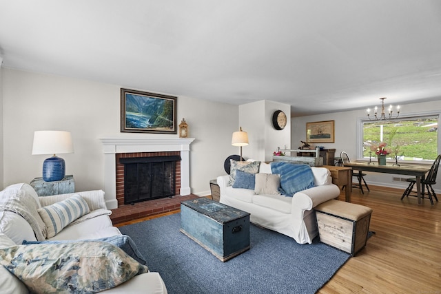 96 Long Hill Ter, New Haven, CT 06515 - living area with wood finished floors, a chandelier, a fireplace, and baseboards