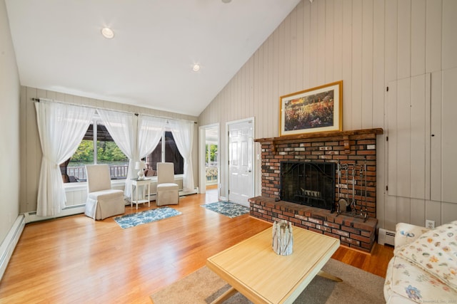 137 Roosevelt Dr, Seymour, CT 06483 - living room featuring a baseboard heating unit, a fireplace, wood finished floors, and high vaulted ceiling