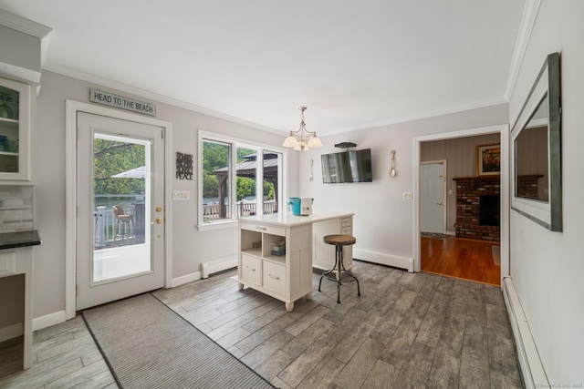 137 Roosevelt Dr, Seymour, CT 06483 - dining room with baseboard heating, crown molding, a chandelier, wood finished floors, and baseboards