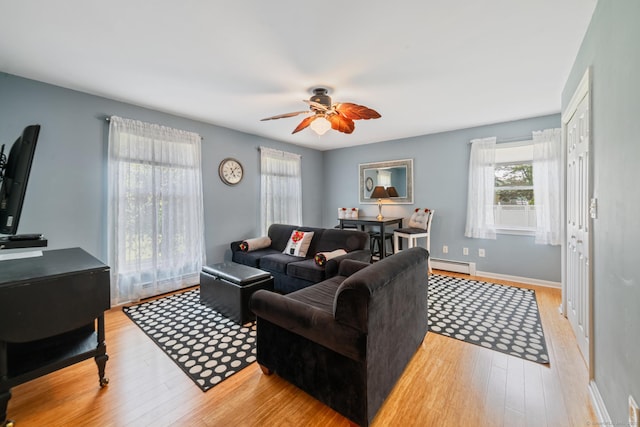 137 Roosevelt Dr, Seymour, CT 06483 - living area with baseboard heating, light wood-style floors, ceiling fan, and baseboards