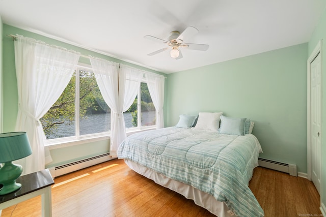137 Roosevelt Dr, Seymour, CT 06483 - bedroom featuring a baseboard heating unit, wood finished floors, a closet, and a ceiling fan