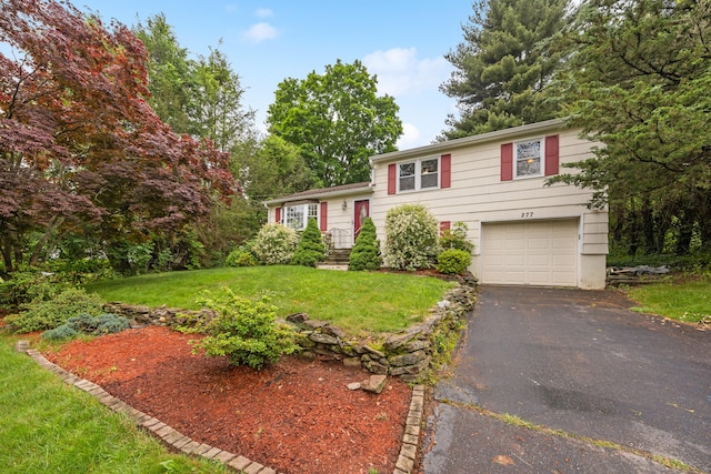277 Tryon St, Middletown, CT 06457 - tri-level home featuring driveway, an attached garage, and a front yard