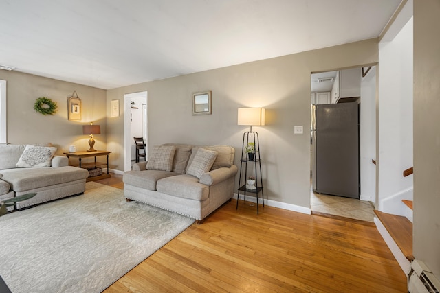 277 Tryon St, Middletown, CT 06457 - living area with baseboard heating, light wood finished floors, and stairs