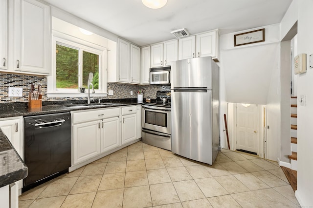 277 Tryon St, Middletown, CT 06457 - kitchen featuring stainless steel appliances, decorative backsplash, white cabinets, and light tile patterned flooring