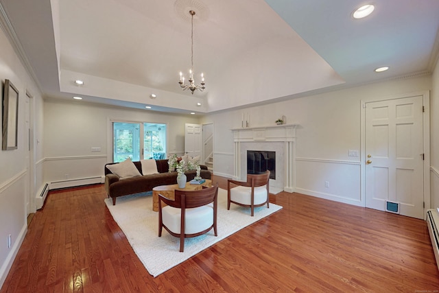 305 Thayer Pond Rd, Wilton, CT 06897 - living area featuring recessed lighting, wood finished floors, a raised ceiling, a chandelier, and a high end fireplace