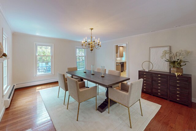 305 Thayer Pond Rd, Wilton, CT 06897 - dining space featuring a chandelier, wood finished floors, crown molding, and baseboards