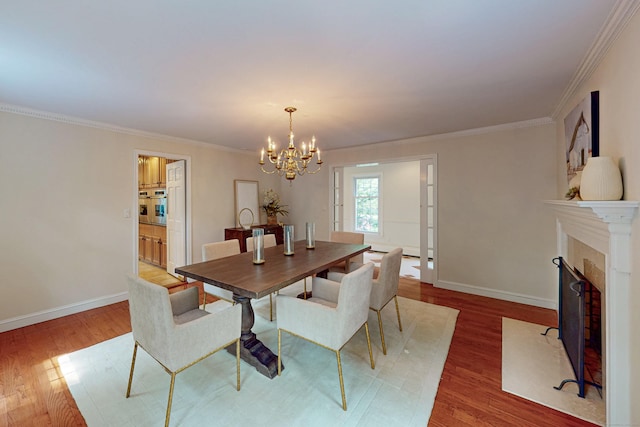 305 Thayer Pond Rd, Wilton, CT 06897 - dining area with a chandelier, wood finished floors, baseboards, and ornamental molding