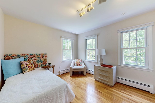 305 Thayer Pond Rd, Wilton, CT 06897 - bedroom featuring baseboard heating, multiple windows, and light wood finished floors