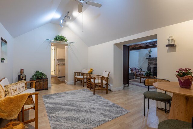 305 Thayer Pond Rd, Wilton, CT 06897 - living area with a ceiling fan, vaulted ceiling, a fireplace, light wood-type flooring, and baseboards