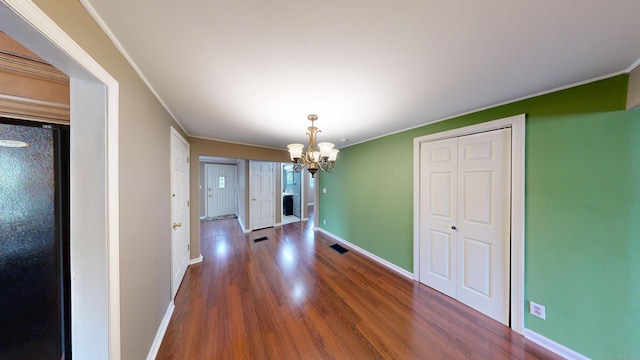 174 Round Hill Rd, Meriden, CT 06450 - unfurnished dining area with a chandelier, wood finished floors, baseboards, and ornamental molding