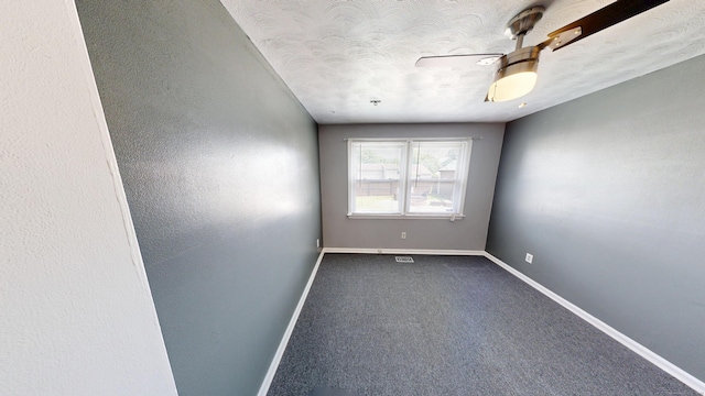 174 Round Hill Rd, Meriden, CT 06450 - empty room with baseboards, a textured ceiling, and dark colored carpet